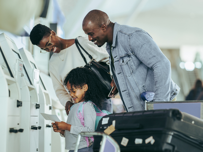 Family of airline passengers - Credit: Jacob Lund - Shutterstock - 1999116965